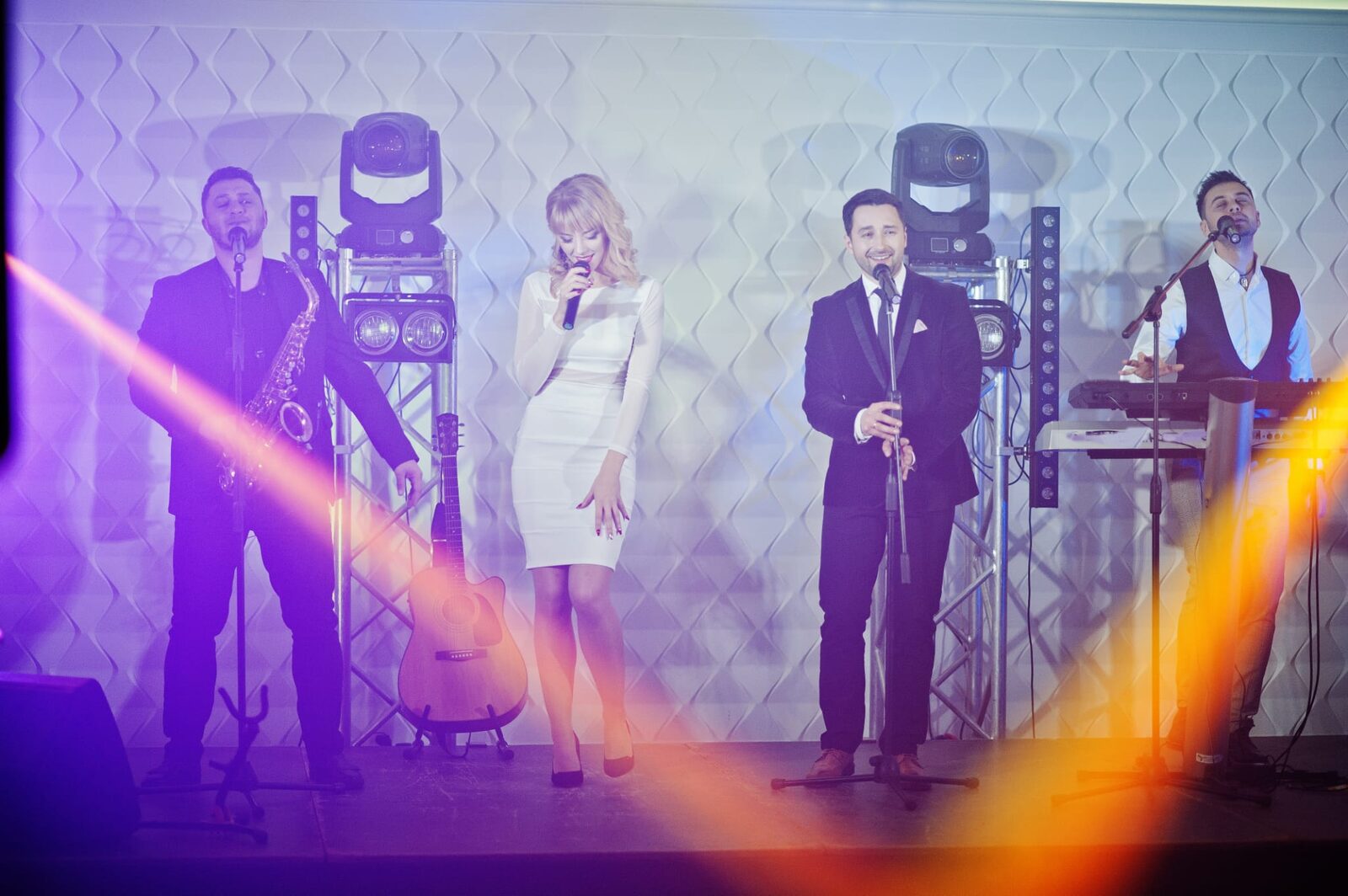 Band performing under coloured lighting