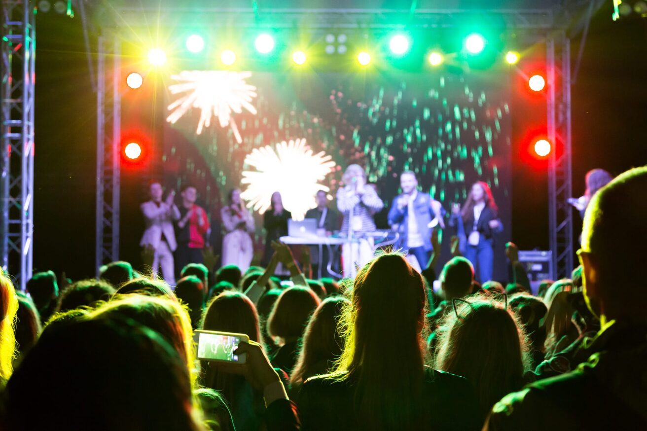 Crowd at a lit outdoor stage